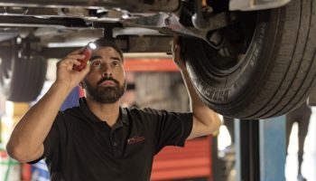 Man servicing underside of car
